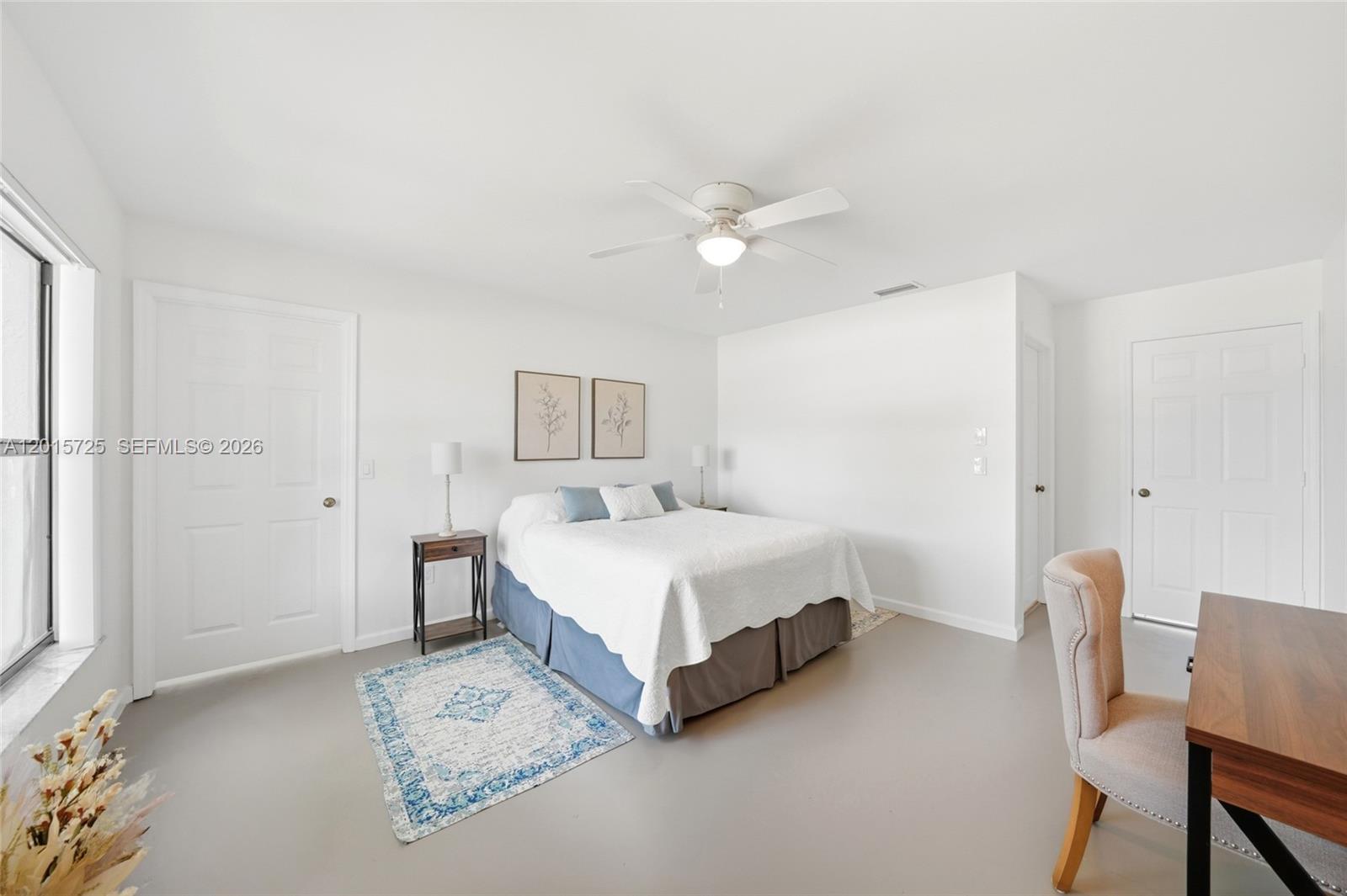 11008 Boca Woods Lane Boca Raton, FL 33428 - Photo 21 of 70 a spacious bedroom with a bed and a table in it