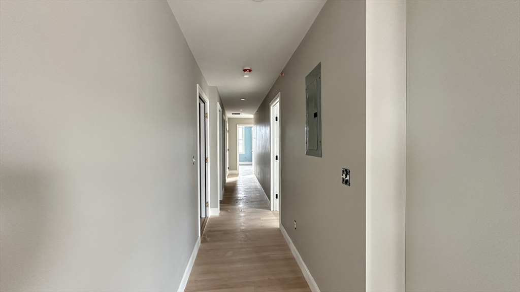 663 Columbia Road, Unit 2 Boston, MA 02125 - Photo 13 of 17 a view of hallway with wooden floor