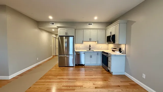 a kitchen with stainless steel appliances a refrigerator and a sink