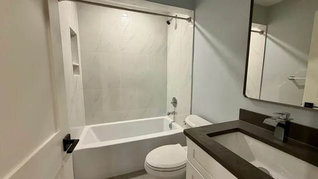 a bathroom with a sink a toilet and a bathtub