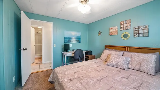 a bedroom with a bed and a table in it