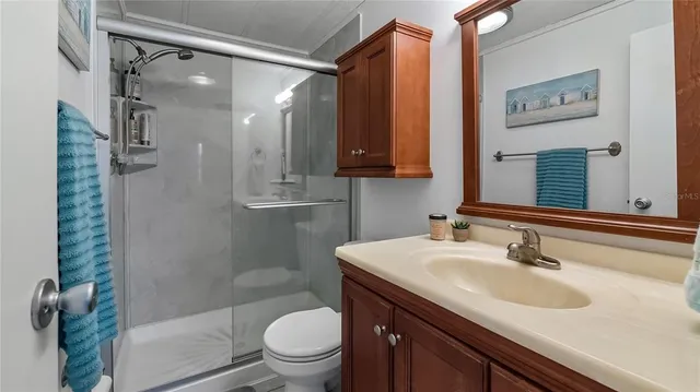 a bathroom with a sink a toilet and shower
