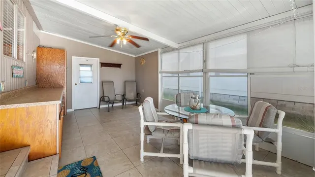 a dining room with furniture and a large window