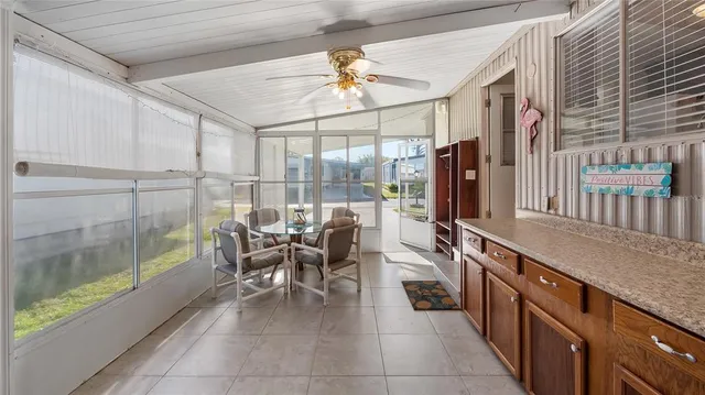 a dining hall with stainless steel appliances granite countertop a refrigerator a sink and a dishwasher