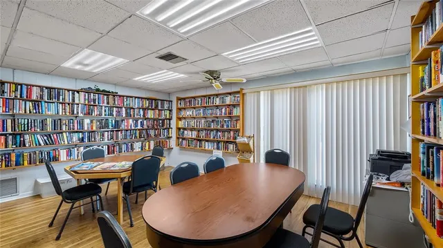 a view of a dining room with furniture chandelier and a large window
