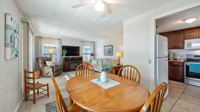 a view of a dining room with furniture a chandelier and wooden floor