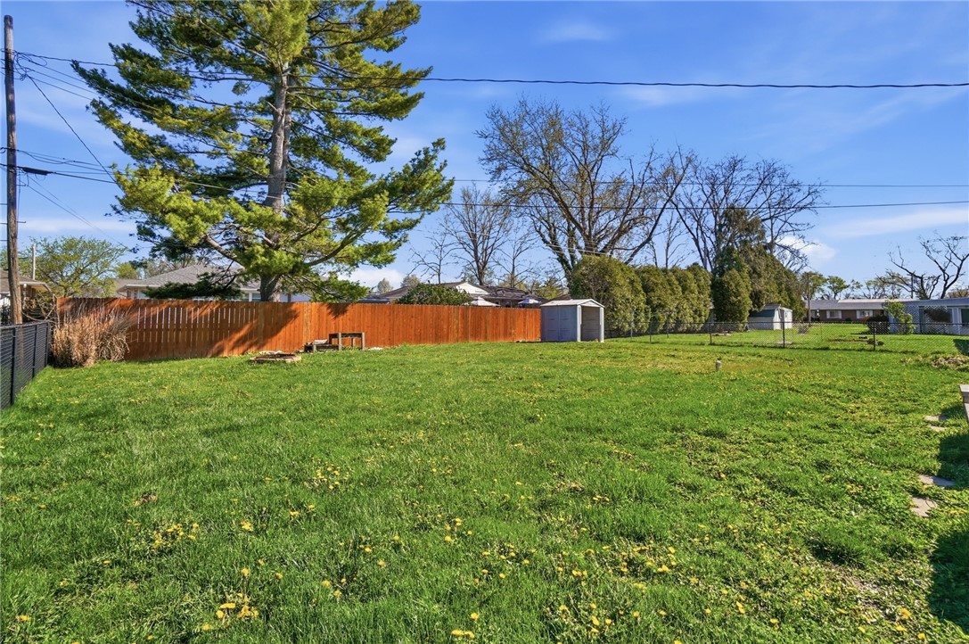 1325 Chelsea Road Troy, OH 45373 - Photo 39 of 42 Expansive green yard with fencing offers ample space for outdoor activities and future enhancements.