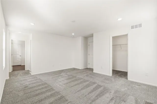 a spacious bathroom with a granite countertop sink and a mirror