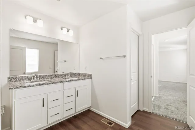 a bathroom with a granite countertop sink mirror and shower