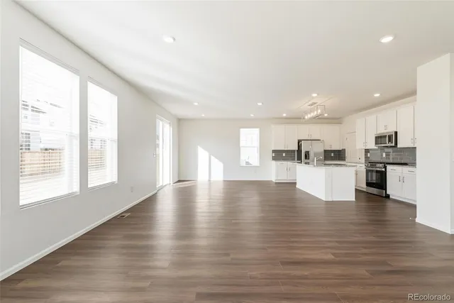 a view of kitchen with kitchen island and stainless steel appliances
