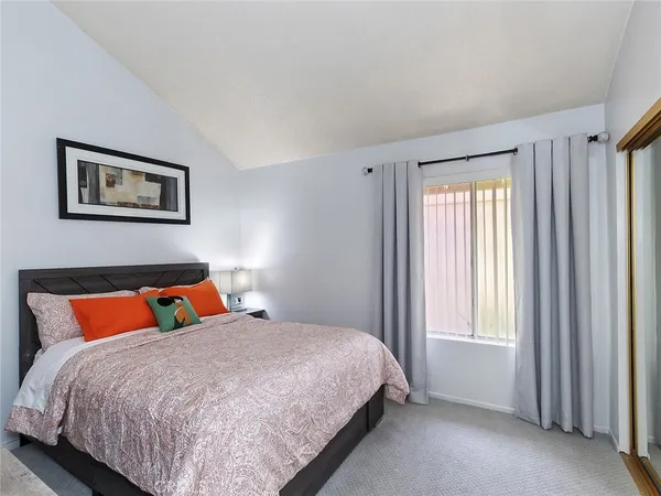 a bed sitting in a bedroom next to a window