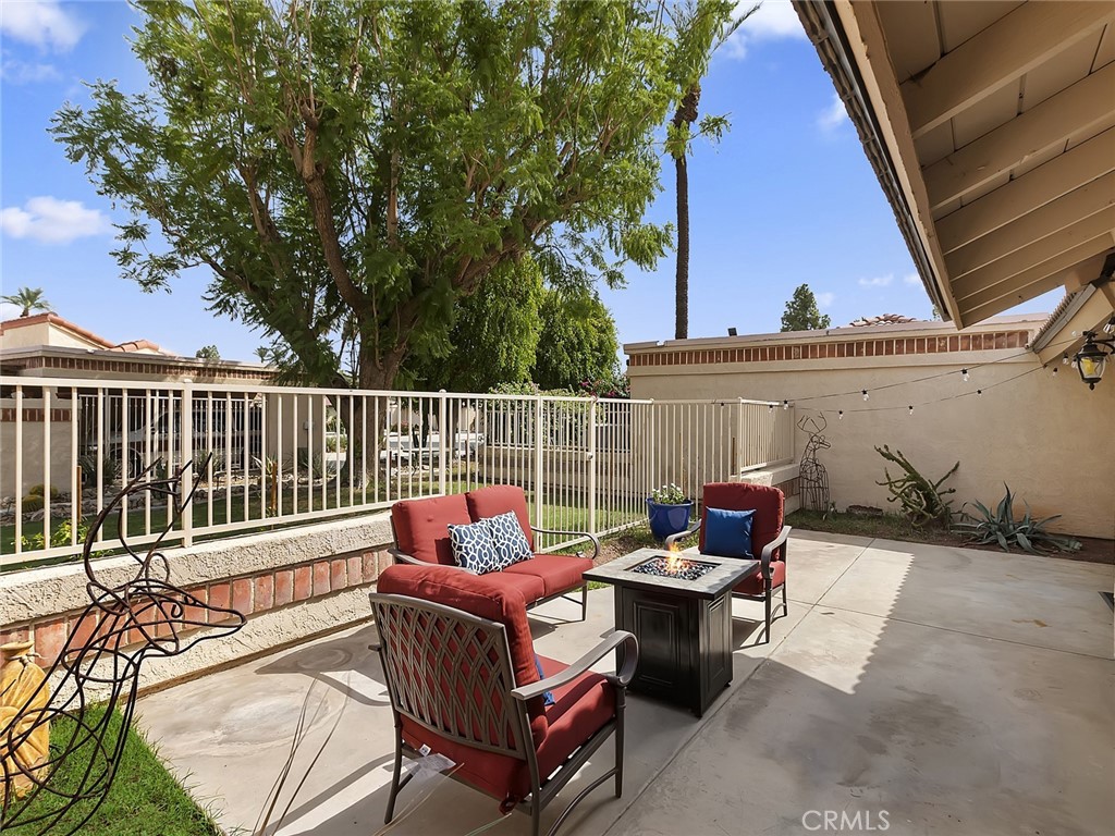 82294 Bergman Drive Indio, CA 92201 - Photo 14 of 22 a view of a patio with couches chairs and wooden fence