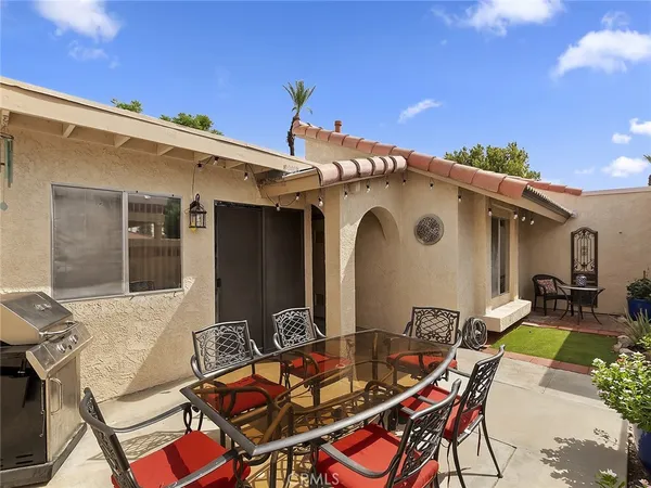 a view of house with patio outdoor dining space and furniture