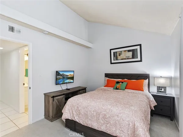 a bedroom with a bed and window