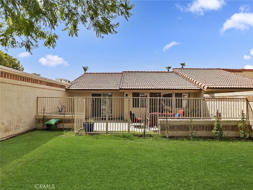 82294 Bergman Drive Indio, CA 92201 - Photo 20 of 22 a front view of a house with a garden