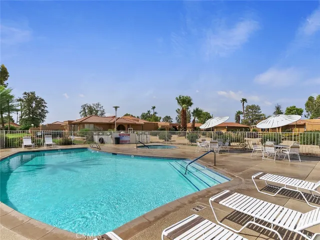 a view of a swimming pool and lounge chairs