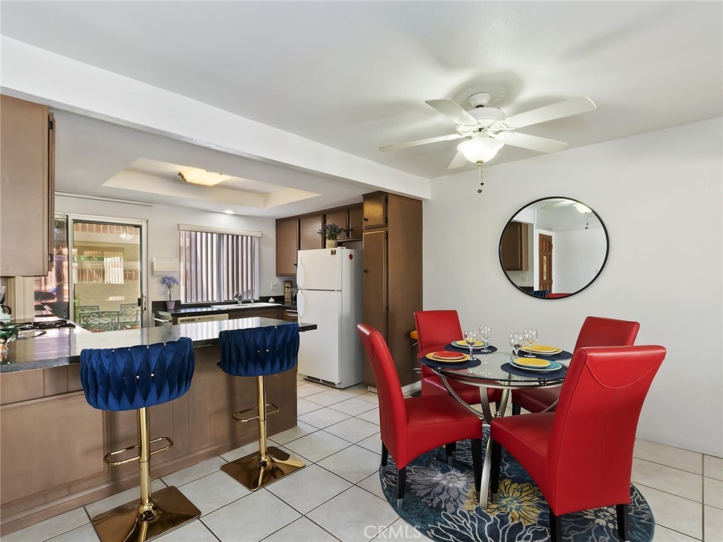 82294 Bergman Drive Indio, CA 92201 - Photo 4 of 22 a dining room with furniture a rug a potted plant and a chandelier