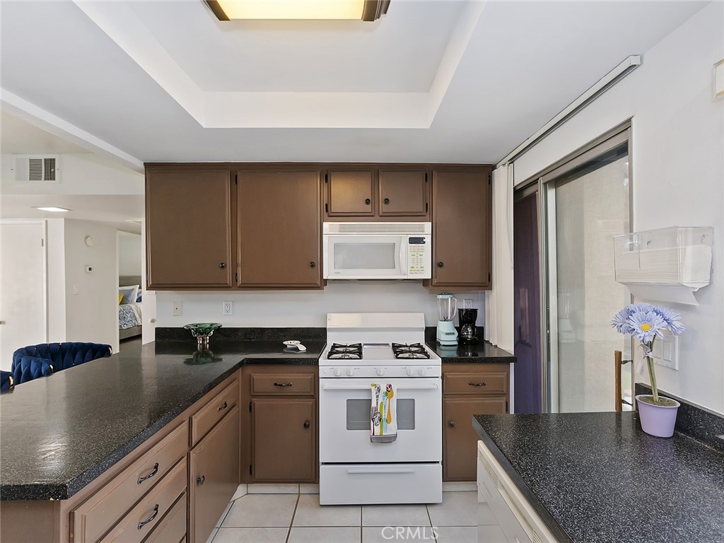 82294 Bergman Drive Indio, CA 92201 - Photo 7 of 22 a kitchen with a stove cabinets and refrigerator