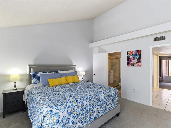 a bedroom with a bed and a couch