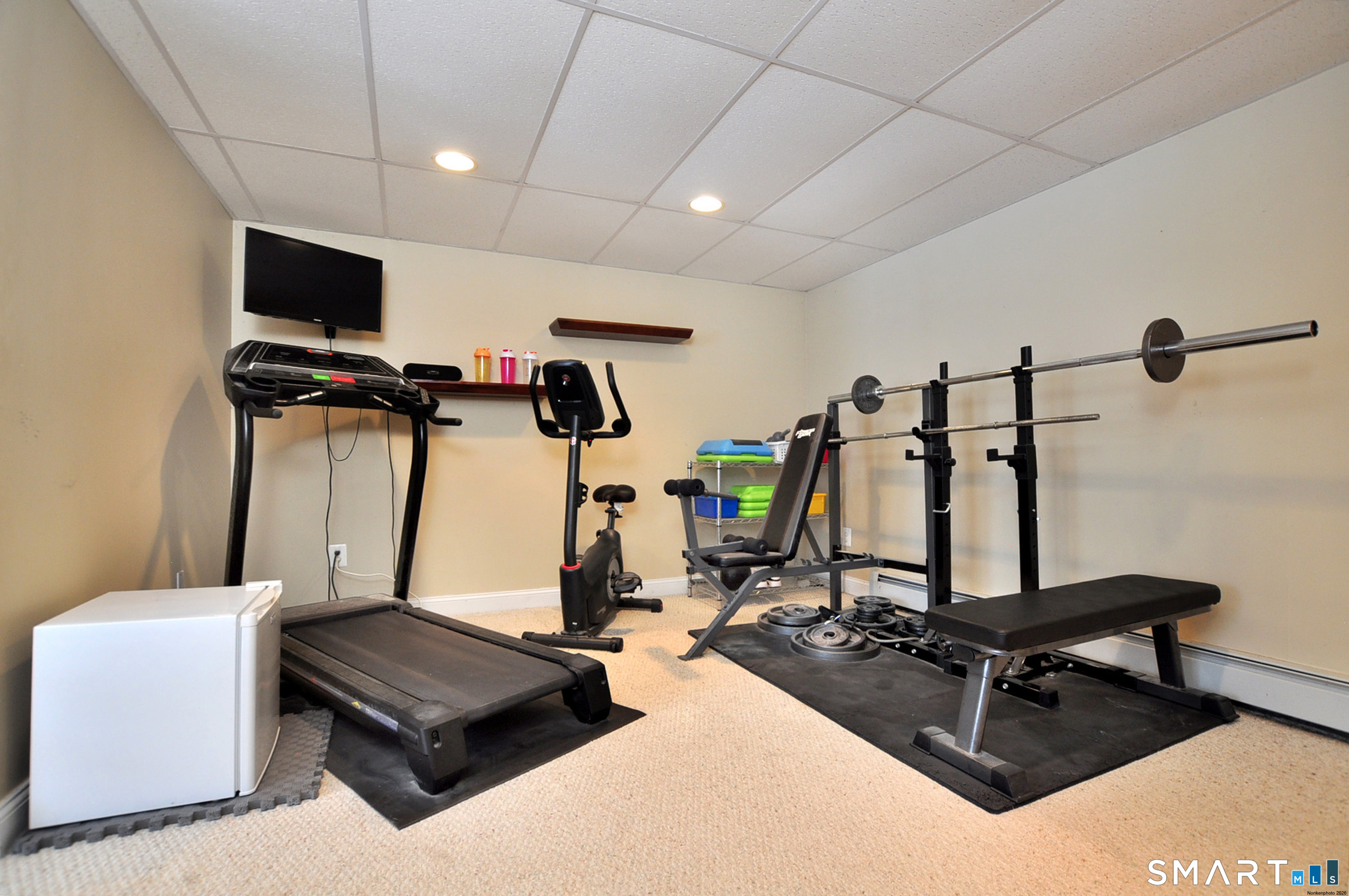 15 Greenwoods Road Granby, CT 06060 - Photo 31 of 41 a room with gym equipment and a flat screen tv