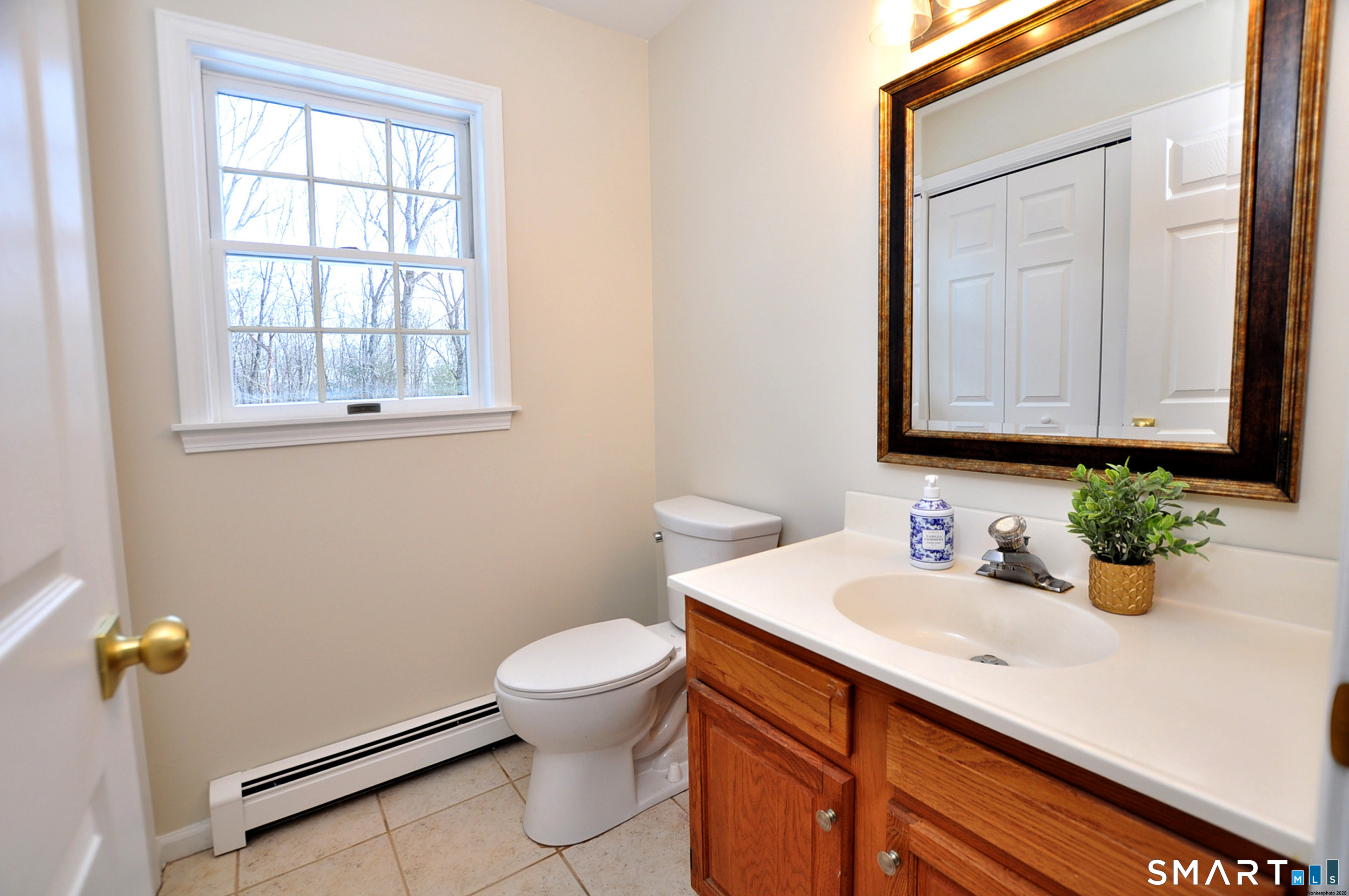 15 Greenwoods Road Granby, CT 06060 - Photo 40 of 41 a bathroom with a sink a toilet and mirror