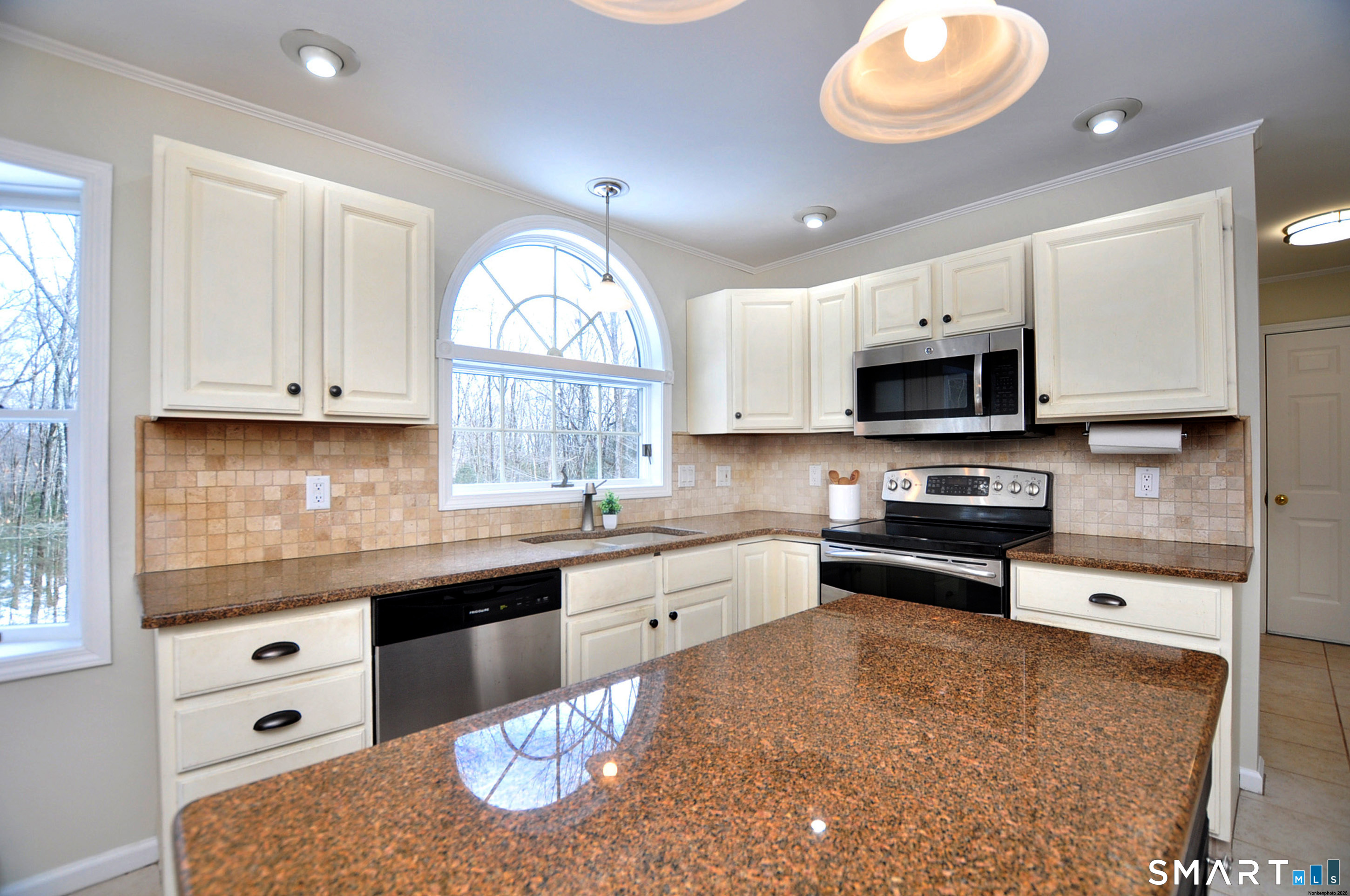 15 Greenwoods Road Granby, CT 06060 - Photo 5 of 41 a kitchen with granite countertop a stove a sink and a white cabinets