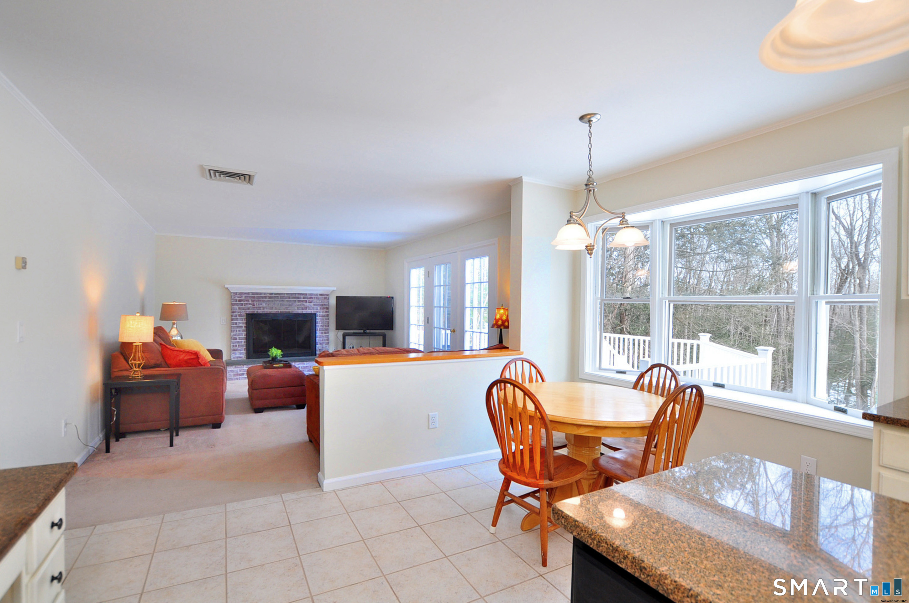 15 Greenwoods Road Granby, CT 06060 - Photo 7 of 41 a living room with furniture a fireplace and a chandelier