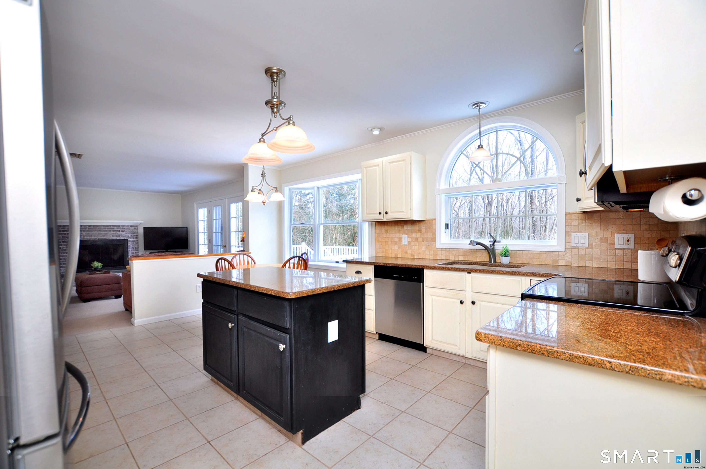 15 Greenwoods Road Granby, CT 06060 - Photo 8 of 41 a kitchen with stainless steel appliances granite countertop a stove a sink dishwasher and a fireplace with wooden floor