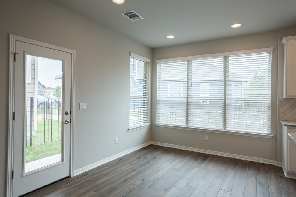 1600 Harwell Loop Kyle, TX 78640 - Photo 13 of 30 a view of an empty room with wooden floor and a window