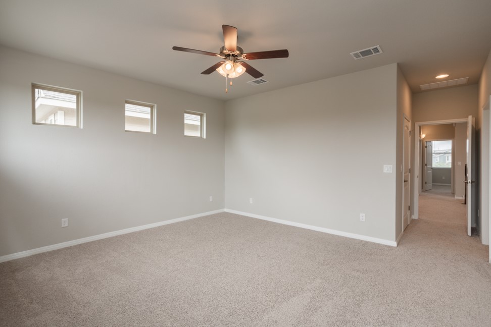 1600 Harwell Loop Kyle, TX 78640 - Photo 18 of 30 a view of an empty room with a ceiling fan