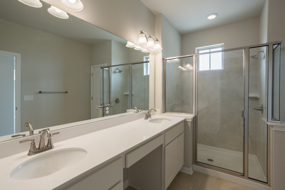 1600 Harwell Loop Kyle, TX 78640 - Photo 20 of 30 a bathroom with a double vanity sink mirror and shower