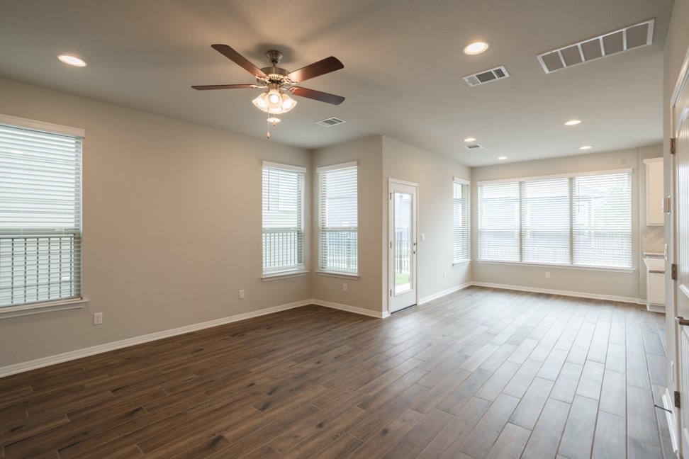1600 Harwell Loop Kyle, TX 78640 - Photo 2 of 30 a view of an empty room with wooden floor and a window