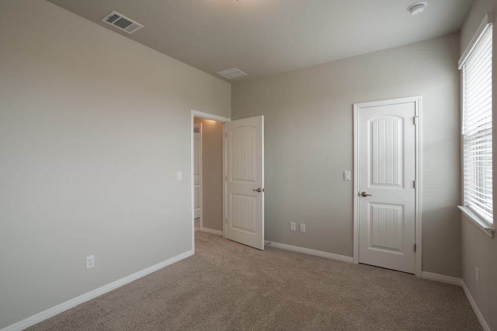 1600 Harwell Loop Kyle, TX 78640 - Photo 28 of 30 an empty room with windows and closet