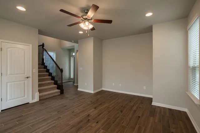 wooden floor in an empty room with a window