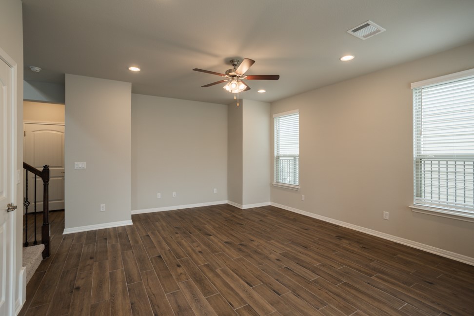 1600 Harwell Loop Kyle, TX 78640 - Photo 5 of 30 wooden floor in an empty room with a window