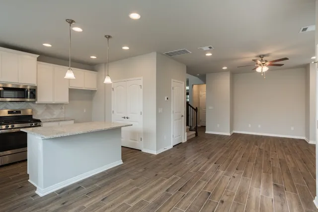 a view of kitchen with stainless steel appliances refrigerator oven and stove