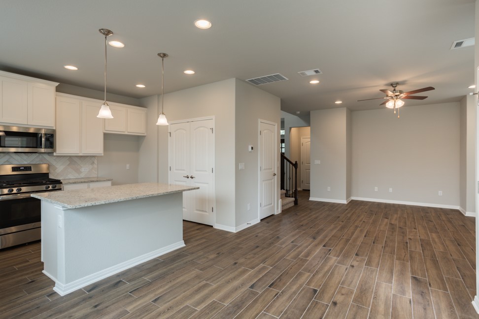 1600 Harwell Loop Kyle, TX 78640 - Photo 7 of 30 a view of kitchen with stainless steel appliances refrigerator oven and stove