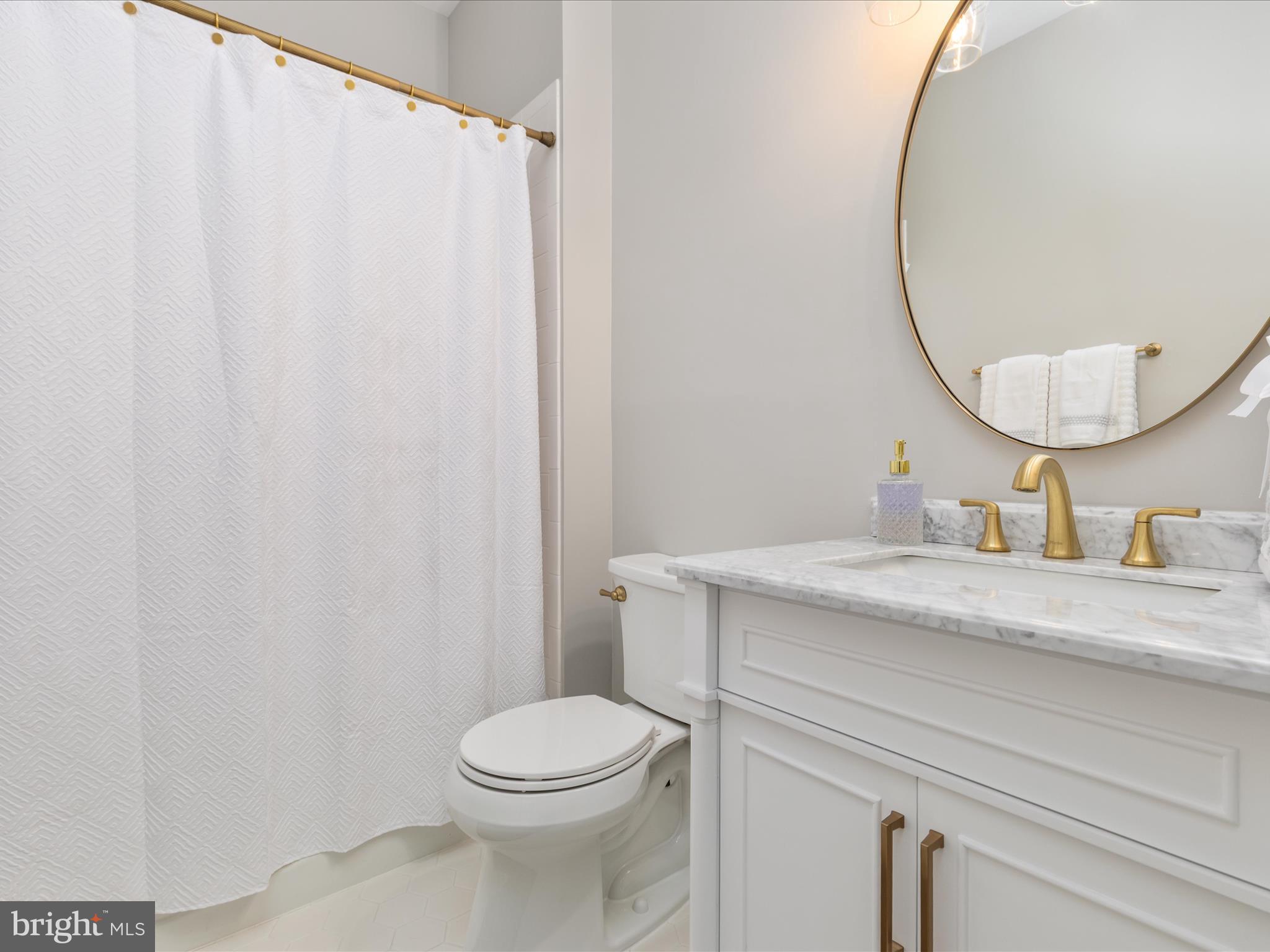 11701 Henderson Road Clifton, VA 20124 - Photo 19 of 61 a bathroom with a granite countertop sink and a mirror