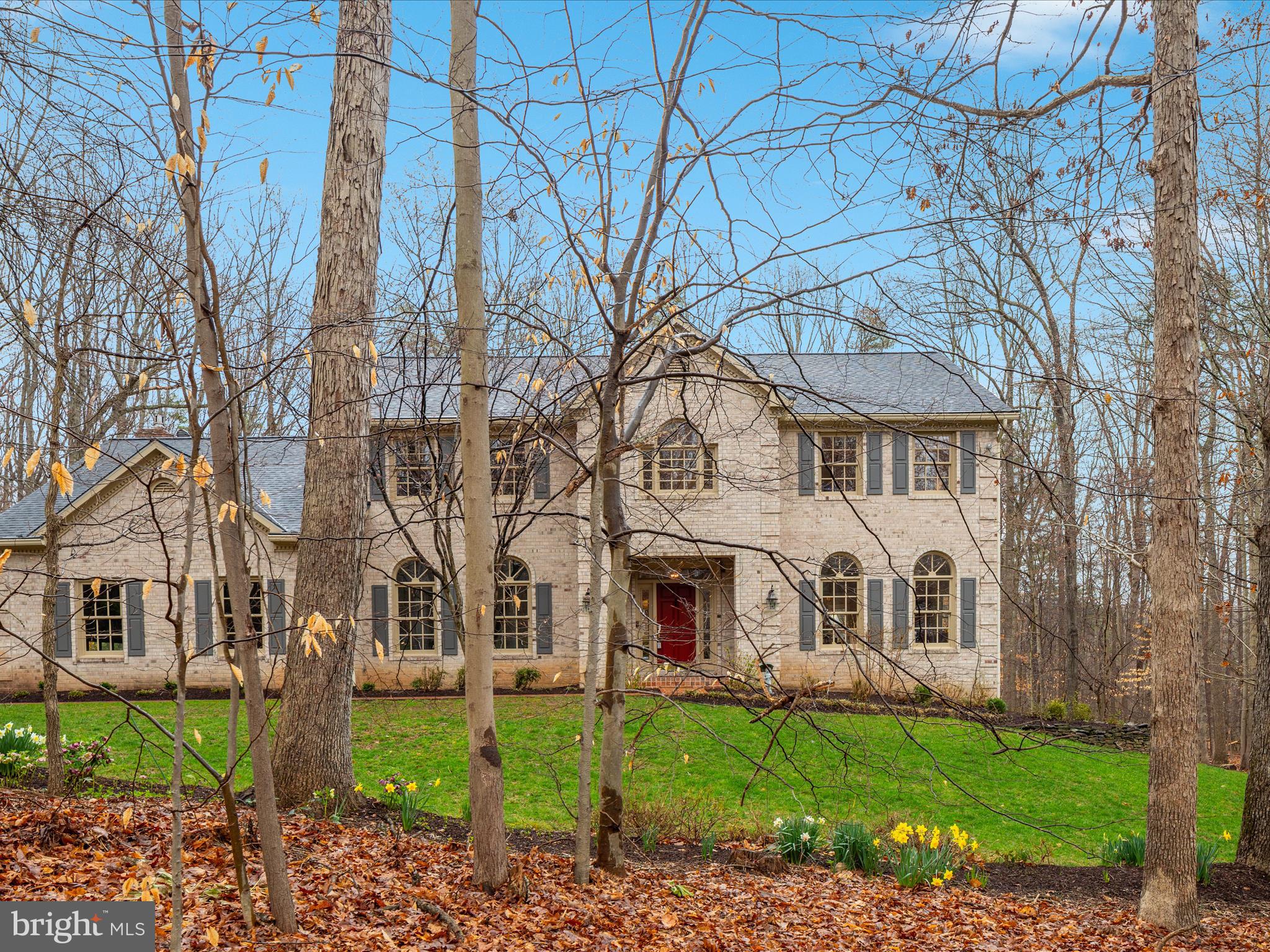 11701 Henderson Road Clifton, VA 20124 - Photo 2 of 61 a view of a white house with a yard and plants