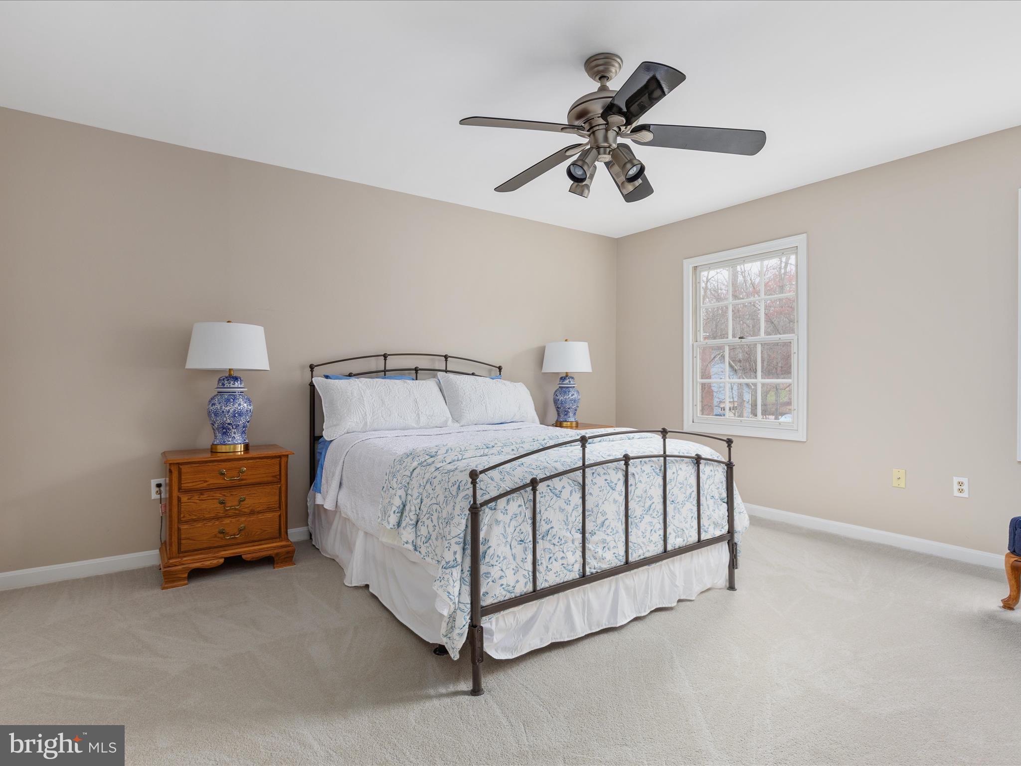 11701 Henderson Road Clifton, VA 20124 - Photo 21 of 61 a spacious bedroom with a bed and a chandelier