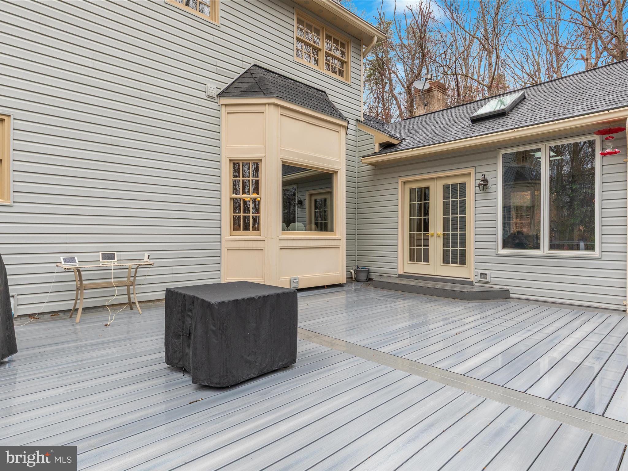 11701 Henderson Road Clifton, VA 20124 - Photo 38 of 61 a view of a deck with table and chairs and wooden floor