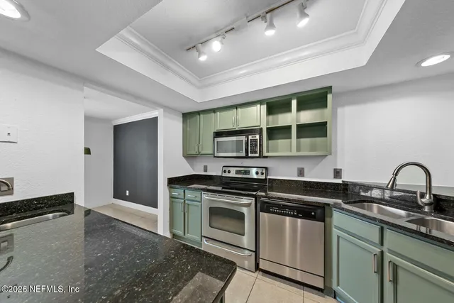 a kitchen with stainless steel appliances granite countertop a stove and a sink