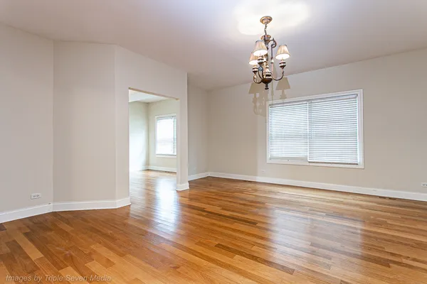 a view of a room with wooden floor closet and windows