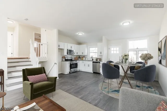 a living room with furniture and kitchen view