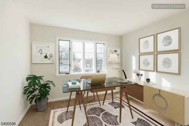 a living room with furniture and large windows