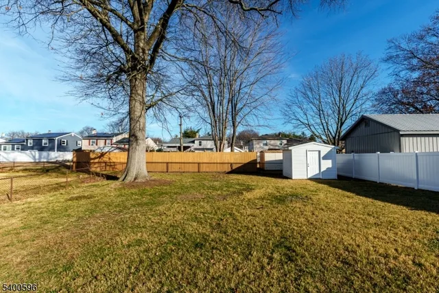 a view of a yard with a house and large trees