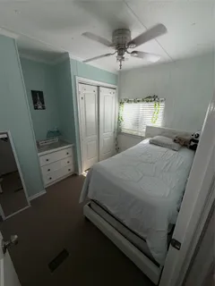 a bed sitting in a room next to a window