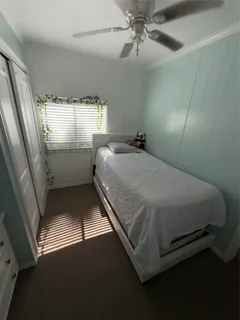 a bed sitting in a bedroom next to a window