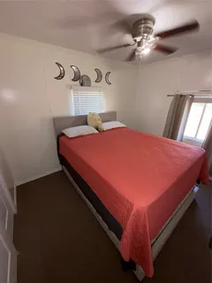 a bedroom with a bed and dresser