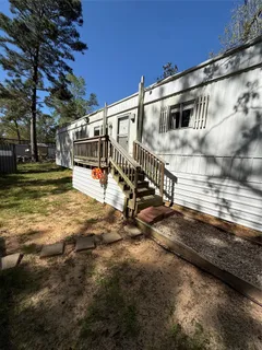 a view of a chairs and deck in the backyard
